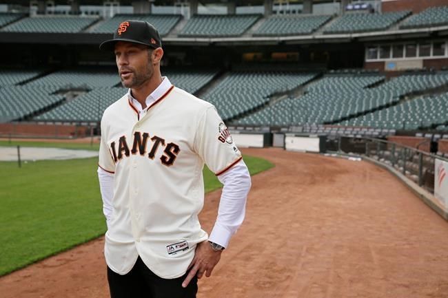 FILE - In this Nov. 13, 2019, file photo, San Francisco Giants manager Gabe Kapler stands on the field and looks out at Oracle Park in San Francisco after being introduced. Kapler knew from the get-go when named San Francisco's new manager the pressure he would feel taking over as leader of a franchise that has had so many good ones in recent memory. (AP Photo/Eric Risberg, File)