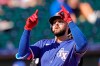 FILE - Texas Rangers' Joey Gallo celebrates as he crosses the plate after hitting a two-run home run during the first inning of a spring training baseball game against the Kansas City Royals, in Surprise, Ariz., in this Sunday, Feb. 28, 2021, file photo. Gallo went into spring training trying to lower his launch angle, straighten up his posture and hit more line drives. The Texas Rangers slugger wasn't worried about trying to hit home runs. (AP Photo/Charlie Riedel, File)