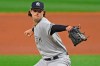 FILE - New York Yankees starting pitcher Gerrit Cole throws in the first inning of Game 1 of an American League wild-card baseball series against the Cleveland Indians in Cleveland, in this Tuesday, Sept. 29, 2020, file photo. The average Major League Baseball salary dropped for an unprecedented third straight year, even before the shortened season caused by the novel coronavirus pandemic. The average fell despite Gerrit Cole, Stephen Strasburg, Anthony Rendon and Christian Yelich all starting long-term contracts guaranteeing $215 million or more. (AP Photo/David Dermer)