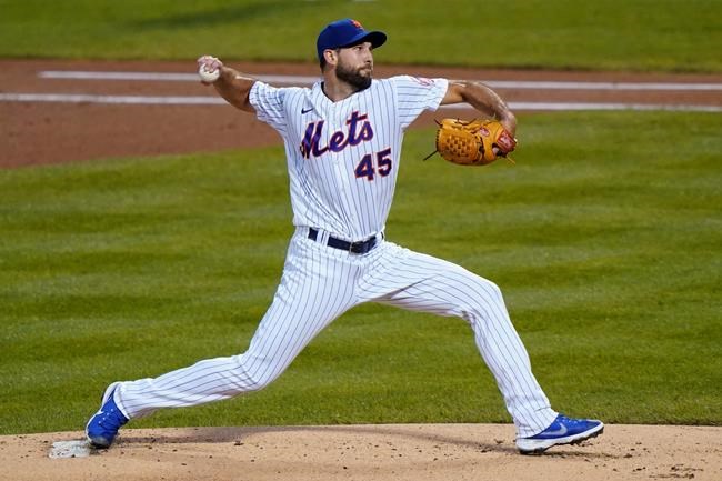 FILE - New York Mets starting pitcher Michael Wacha winds up during the first inning of the team's baseball game against the Baltimore Orioles in New York, in this Tuesday, Sept. 8, 2020, file photo. The American League champion Tampa Bay Rays signed right-hander Michael Wacha to a $3 million, one-year contract on Friday, Dec. 18, 2020, to fill a void in the rotation with the departure of Charlie Morton. The 29-year old Wacha has a 60-43 record with a 4.01 ERA over eight seasons. After seven years with the St. Louis Cardinals, he went went 1-4 with a 6.62 ERA with the New York Mets in 2020. (AP Photo/Kathy Willens, File)