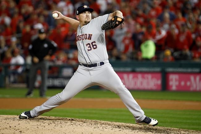 FILE - In this Oct. 25, 2019, file photo, Houston Astros relief pitcher Will Harris throws against the Washington Nationals during the seventh inning of Game 3 of the baseball World Series, in Washington. Relief pitcher Will Harris is joining the Washington Nationals after they beat him in Game 7 of the World Series against the Houston Astros. Harris and the Nationals have agreed to a $24 million, three-year contract, according to a person with direct knowledge of the deal. The person spoke to The Associated Press on condition of anonymity Friday, Jan. 3, 2020, because the agreement has not been announced. (AP Photo/Patrick Semansky, File)