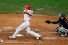 FILE - Philadelphia Phillies' J.T. Realmuto follows through after hitting a two-run home run off Atlanta Braves pitcher Robbie Erlin during the fourth inning of a baseball game in Philadelphia, in this Monday, Aug. 10, 2020, file photo. The Philadelphia Phillies and two-time All-Star catcher J.T. Realmuto agreed on a $115.5 million, five-year contract, two people familiar with the deal told The Associated Press. Both people spoke to The Associated Press on condition of anonymity Tuesday, Jan. 26, 2021, because Realmuto’s deal was pending a successful physical.(AP Photo/Matt Slocum, File)