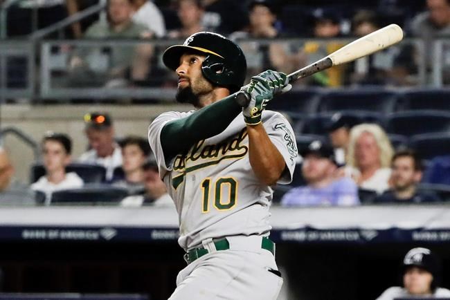 FILE - In this Aug. 30, 2019, file photo, Oakland Athletics' Marcus Semien watches his home run during the ninth inning of the team's baseball game against the New York Yankees in New York. Following a career year, Semien was rewarded Friday, Jan. 10, with a $13 million, one-year contract that avoids arbitration and gives him a raise of $7.1 million. Semien played all 162 games for the first time in 2019 to help the A's win 97 games for a second straight season and the AL's top wild card. He finished third in MVP voting after putting up several personal bests: 33 homers and 92 RBIs while hitting .285. (AP Photo/Frank Franklin, File)