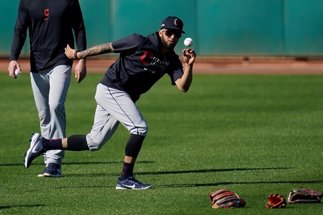 Cleveland Indians outfielder Eddie Rosario reaches out to catch a baseball during a spring training baseball practice Monday, Feb. 22, 2021, in Goodyear, Ariz. Once adversaries, Eddie Rosario and Indians manager Terry Francona are now allies. So when Rosario, who spent the past six seasons with Minnesota, sat down with Francona at spring training camp in Arizona for the first time last week, the free-swinging outfielder received a warm, if not awkward, welcome.(AP Photo/Ross D. Franklin)