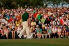 FILE - Louis Oosthuizen, of South Africa, watches his putt on the 18th green during the fourth round of the Masters golf tournament in Augusta, Ga., in this Sunday, April 8, 2012, file photo. The 18th green will be missing patrons when the Masters champion wins a green jacket this year.(AP Photo/David J. Phillip, File)