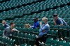 FILE - Seattle Mariners general manager Jerry Dipoto, second from left, manager Scott Servais, right, and team president and CEO Kevin Mather, second from right, watch from the stands during baseball practice in Seattle, in this July 8, 2020, file photo. Seattle Mariners general manager Jerry Dipoto and manager Scott Servais are doing damage control with players who were directly mentioned or referenced by former team CEO Kevin Mather in an online video that led to his resignation. (AP Photo/Ted S. Warren, File)