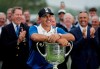 FILE - In this May 19, 2019, file photo, Brooks Koepka poses with the Wanamaker Trophy after winning the PGA Championship golf tournament at Bethpage Black in Farmingdale, N.Y. Brooks Koepka will try to become the first player to win the PGA Championship three straight times in stroke play, and there won't be anyone at Harding Park to cheer him on. The PGA of America confirmed Monday, June 22, 2020, the first major of this most unusual year won't have spectators.(AP Photo/Julio Cortez, FIle)