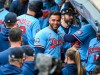 FILE - In this Sept. 27, 2020, file photo, Minnesota Twins' Nelson Cruz, center, smiles in the dugout after the Twins clinched the AL Central championship with the Chicago White Sox's loss during the tenth inning of a baseball game in Minneapolis. The Minnesota Twins are bringing back designated hitter Nelson Cruz on a one-year, $13 million contract, according to a person with knowledge of the negotiations. The agreement was reached late Tuesday and confirmed Wednesday, Feb. 3, 2021, to The Associated Press on condition of anonymity because the deal was pending completion of a physical exam.(AP Photo/Craig Lassig, File)