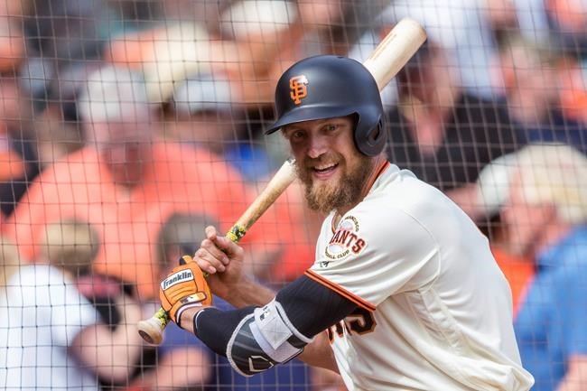 FILE - In this Sept. 30, 2018, file photo, San Francisco Giants Hunter Pence waits on deck club before batting against the Los Angeles Dodgers in the ninth inning of a baseball game in San Francisco. Pence is returning to the Giants, agreeing to a contract that will give the young club a veteran presence in both the outfield and clubhouse in a season of big change ahead. A person with direct knowledge of the deal said Friday, Feb. 7, 2020, that Pence had reached agreement pending a physical. The person spoke to The Associated Press on condition of anonymity because no announcement had been made. (AP Photo/John Hefti)