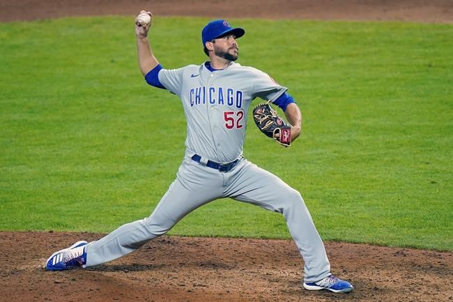 FILE - Chicago Cubs relief pitcher Ryan Tepera (52) pitches during a baseball game against the Cincinnati Reds at Great American Ball Park in Cincinnati, in this Monday, July 27, 2020, file photo. The Cubs finalized an $800,000, one-year deal with reliever Ryan Tepera on Tuesday, March 2, 2021, a deal that allows him to earn up to $1.75 million, and opened a roster spot by designating right-hander Duane Underwood Jr. for assignment. (AP Photo/Bryan Woolston, File)