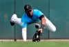 FILE - In this Friday, March 1, 2019 file photo, Miami Marlins center fielder Lewis Brinson dives to catch a fly ball by Washington Nationals' Adam Eaton for an out during the third inning of an exhibition spring training baseball game in Jupiter, Fla. A five-person panel of Major League Baseball players, coaches and executives discussed ways to get more Black people involved at all levels of the sport. Lewis Brinson was on the panel.(AP Photo/Jeff Roberson, File)