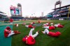 FILE - In this April 7, 2017, file photo, members of the Philadelphia Phillies stretch before the team's baseball game against the Washington Nationals in Philadelphia. Five players for the Philadelphia Phillies have tested positive for COVID-19 at the team's spring camp in Florida, prompting the club to indefinitely close the complex. The team also said Friday, June 19, 2020, that three staff members at the camp have tested positive. The club didn't identify any of those affected. (AP Photo/Matt Rourke, File)