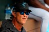 FILE - Miami Marlins manager Don Mattingly looks on from the dugout prior to a spring training baseball game against the Washington Nationals in Jupiter, Fla., in this Tuesday, March 10, 2020, file photo. Mattingly's job remains to develop young talent so an underfinanced team can overachieve. He considers his ability to relate to players one of his strengths, perhaps because he was an overachiever himself. (AP Photo/Julio Cortez, File)