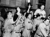 FILE - This Oct. 8, 1939, file photo shows New York Yankees baseball players celebrating in the locker room after beating the Cincinnati Reds 7-4 in Game 4 to win the World Series, at Crosby Field in Cincinnati. Babe Dahlgren is at left foreground. Buddy Rosar is at center holding up his hat and coach Art Fletcher, stands on a trunk, second from right. (AP Photo/File)