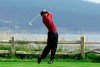 FILE - In this June 18, 2000, file photo, Tiger Woods tees off on the 18th hole on his way to winning the 100th U.S. Open Golf Championship at the Pebble Beach Golf Links in Pebble Beach, Calif. Golf Channel is airing a one-hour special on May 24 of Woods winning all four majors in a span of 10 months. (AP Photo/Elise Amendola, File)