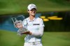 FILE - In this June 30, 2019, file photo, Sung Hyun Park holds up the trophy after winning the LPGA Walmart NW Arkansas Championship golf tournament in Rogers, Ark. Jin Young Ko and Sung Hyun Park were Nos. 1 and 2 in the women's world golf ranking when they left Florida on Nov. 24 after the LPGA Tour season finale. They skipped the opening two events in Florida and two others in Australia and planned to return to competition during the Asia swing. That's when the spread of COVID-19 halted sports. (AP Photo/Michael Woods, File)