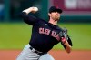 FILE - In this Aug. 31, 2020, file photo, Cleveland Indians starting pitcher Shane Bieber throws during the first inning of the team's baseball game against the Kansas City Royals in Kansas City, Mo. Indians ace Shane Bieber recently tested positive with COVID-19, delaying the AL Cy Young winner's arrival at training camp. President of baseball operations Chris Antonetti said Thursday, Feb. 18, 2021, that Bieber has only dealt with “very mild symptoms” from the virus. Antonetti anticipates that Bieber, who had been working out at the team's training complex in Goodyear, Arizona, will join the club in the next few days.(AP Photo/Charlie Riedel, File)
