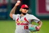 FILE - In this Wednesday, Sept. 23, 2020 file photo, St. Louis Cardinals relief pitcher Carlos Martinez throws during the first inning of a baseball game against the Kansas City Royals in Kansas City, Mo. One year later, there's a better understanding of what it takes to play a baseball season amid a pandemic. Pitchers and catchers reported to spring training Wednesday, Feb. 17, 2021. (AP Photo/Charlie Riedel, File)