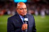 FILE - In this Sept. 5, 2019, file photo, NBC sportscaster Mike Tirico works the sidelines during an NFL football game between the Green Bay Packers and the Chicago Bears in Chicago. Tirico is one of many announcers who has had to trade the press box for a home office. (AP Photo/Jeff Haynes, File)