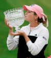 FILE - In this May 22, 2005, file photo, Paula Creamer kisses the trophy after winning the LPGA Sybase Classic in New Rochelle, N.Y. It was 15 years ago this week that Creamer won her first pro title, five days before her high school graduation. (AP Photo/Ed Betz, File)