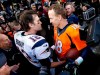 FILE - In this Jan. 24, 2016, file photo, New England Patriots quarterback Tom Brady, left, and Denver Broncos quarterback Peyton Manning speak to one another following the NFL football AFC championship game in Denver. The next match involving Tiger Woods and Phil Mickelson involves a $10 million donation for COVID-19 relief efforts, along with plenty of bragging rights in a star-powered foursome May 24 at Medalist Golf Club. Turner Sports announced more details Thursday, May 7, 2020, for “The Match: Champions for Charity,” a televised match between Woods and Peyton Manning against Mickelson and Tom Brady. (AP Photo/David Zalubowski, File)