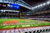 FILE - The Texas Rangers and Colorado Rockies line the foul lines of Globe Life Field before an opening day baseball game in Arlingtn, Texas, in this Friday, July 24, 2020, file photo. The Texas Rangers could have a full house for their home opener next month after debuting their new 40,518-seat stadium without fans in the stands for their games last season. If that happens, the Rangers could be the first team in MLB or any U.S.-based sport to have a full-capacity crowd since the coronavirus pandemic started rapidly shutting down sports a year ago this week. (AP Photo/Jeffrey McWhorter, File)