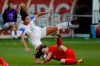 FILE - In this Feb. 7, 2020, file photo, Costa Rica forward Raquel Rodriguez, top, is knocked over by Canada defender Allysha Chapman during the first half of a CONCACAF women's Olympic qualifying soccer match in Carson, Calif. Raquel Rodriguez, better known as Rocky to her fans, was in route to join her new National Women’s Soccer League team when sports were shut down by the coronavirus. It certainly wasn’t an ideal start for the Costa Rican striker with the Portland Thorns. (AP Photo/Chris Carlson, Fle)