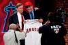 FILE - In this June 9, 2009, file photo, Baseball Commissioner Bud Selig poses with Mike Trout, an outfielder from New Jersey's Millville High School, who was picked 25th by the Los Angeles Angels in the baseball draft in Secaucus, N.J. Baseball’s amateur draft this week will look much different because of the coronavirus pandemic, and more permanent changes could be coming soon. (AP Photo/Rich Schultz, File)