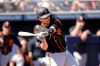 FILE - In this Sunday, March 1, 2020 file photo, San Francisco Giants' Buster Posey bats during the first inning of a spring training baseball game against the against the San Diego Padres in Peoria, Ariz. Posey has spent the past seven months in serious multitasking mode, working to stay in baseball shape while on full-time dad duty to two sets of twins. Son Lee's twin sister is Addison. (AP Photo/Charlie Riedel, File)