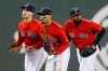 FILE - In this Friday, April, 12, 2019 file photo, Boston Red Sox's Andrew Benintendi, left, Mookie Betts, center, and Jackie Bradley Jr. run in after defeating the Baltimore Orioles during a baseball game in Boston. When the Boston Red Sox traded Mookie Betts to the Los Angeles Dodgers on the eve of spring training, they broke up the