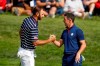 FILE - In this Sept. 28, 2018, file photo, Dustin Johnson left, and Rory McIlroy shake hands on 16th green at the end of a fourball match on the opening day of the 42nd Ryder Cup in Saint-Quentin-en-Yvelines, outside Paris, France. Johnson and McIlroy headline a $3 million charity match for COVID-19 relief that will mark the first live golf on television since the pandemic shut down sports worldwide. The May 17 match will be played at Seminole Golf Club in South Florida. (AP Photo/Alastair Grant, File)
