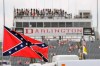 FILE - In this Sept. 5, 2015, file photo, a Confederate flag flies in the infield before a NASCAR Xfinity auto race at Darlington Raceway in Darlington, S.C. Bubba Wallace, the only African-American driver in the top tier of NASCAR, calls for a ban on the Confederate flag in the sport that is deeply rooted in the South. (AP Photo/Terry Renna, File)
