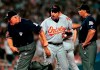 FILE - In this Friday, July 2, 1999 file photo, Baltimore Orioles manager Ray Miller, center, is ejected from the game by first base umpire Larry Barnett, left, as second base umpire Greg Kosc looks on during the fifth inning against the New York Yankees in New York. Former Minnesota Twins and Baltimore Orioles manager Ray Miller, who spent 42 seasons in professional baseball and served as the pitching coach for three Cy Young award winners, has died, Tuesday, May 4, 2021. He was 76. (AP Photo/Bill Kostroun)