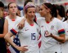 FILE - In this July 7, 2019, file photo, United States' Megan Rapinoe, left, talks to her teammate Alex Morgan, right, after winning the Women's World Cup final soccer match against Netherlands at the Stade de Lyon in Decines, outside Lyon, France. Players for the U.S. women’s national team may have been dealt a blow by a judge’s ruling in their gender discrimination case against U.S. Soccer, but the case is far from over. On Friday a federal judge threw out the players' unequal pay in a surprising loss for the defending World Cup champions. But the judge allowed aspects of their allegations of discriminatory working conditions to go to trial. (AP Photo/Alessandra Tarantino, File)