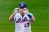 FILE - In this Thursday, Sept. 3, 2020 file photo, New York Mets' Todd Frazier gestures toward teammates in the dugout after hitting a double during the fourth inning of the team's baseball game against the New York Yankees in New York. Infielder Todd Frazier has agreed to a minor league deal with the Pittsburgh Pirates that includes an invitation to big league spring training. If Frazier is added to the 40-man roster, he would get a one-year contract paying a $1.5 million salary while in the major leagues. (AP Photo/Kathy Willens, File)