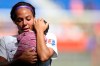 FILE - In this Sunday, Sept. 29, 2019 file photo, Orlando Pride forward Sydney Leroux (2) holds her child on the pitch after an NWSL soccer match against Sky Blue FC in Harrison, N.J. Sydney Leroux simply isn't done chasing her soccer dreams. The veteran forward signed a 3-year max deal with the Orlando Pride, the National Women's Soccer League team she's been with since 2018. Announced Wednesday, Feb. 3, 2021 the contract has an option for an additional year. (AP Photo/Steve Luciano, File)