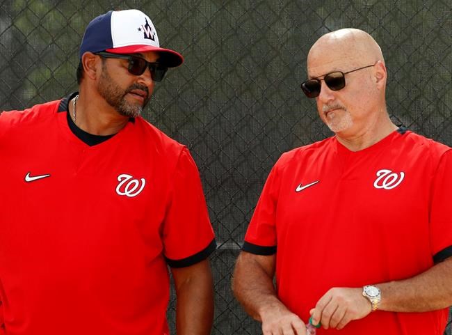 FILE - In this Feb. 17, 2020, file photo, Washington Nationals manager Dave Martinez, left, talks with general manager Mike Rizzo during spring training baseball practice in West Palm Beach, Fla. Nationals general manager Mike Rizzo says his top offseason priority is adding a middle-of-the-order hitter. (AP Photo/Jeff Roberson, File)