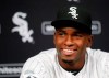 FILE - In this May 27, 2017, file photo, Luis Robert smiles during a news conferences after signing with the Chicago White Sox before a baseball game between the White Sox and the Detroit Tigers in Chicago. The White Sox and Robert agreed Thursday, Jan. 2, 2020, to a $50 million, six-year contract, clearing the way for the prized outfielder to open the season in the majors. The deal, which also includes club options for 2026 and 2027, removes the incentive for the White Sox to keep the 22-year-old Cuban off their opening day roster to limit his service time and delay his eventual free agency.(AP Photo/Charles Rex Arbogast, File)