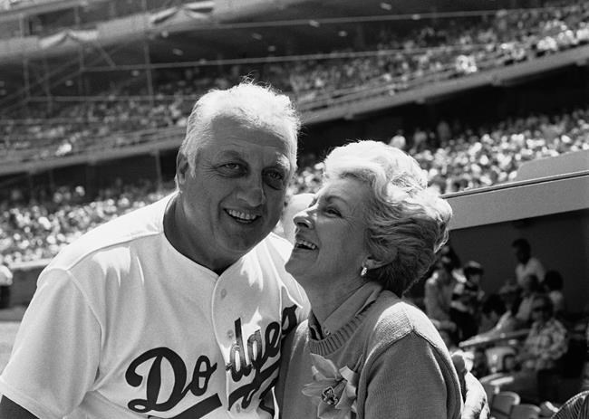 FILE - Jo Lasorda, wife of Los Angeles Dodgers' manager Tommy Lasorda, leans up to give him a good luck kiss on the start of his 35th season with the Dodger organization, in Los Angeles in this April 4, 1984, file photo. Tommy Lasorda, the fiery Hall of Fame manager who guided the Los Angeles Dodgers to two World Series titles and later became an ambassador for the sport he loved during his 71 years with the franchise, has died. He was 93. The Dodgers said Friday, Jan. 8, 2021, that he had a heart attack at his home in Fullerton, California. (AP Photo/Lennox Mclendon, File)