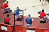 FILE - In this July 5, 2020, file photo, Boston Red Sox players sit apart for social distancing during baseball practice at Fenway Park in Boston. Public health experts have mixed feelings about baseball’s hopes to open its season July 23. There is optimism because of the nature of the sport itself, which produces less on-field risk than basketball, football or hockey. Then again, players and their families face a daunting task staying safe away from the ballpark, especially with teams traveling to and from hard-hit regions including Florida and Texas. (AP Photo/Michael Dwyer)
