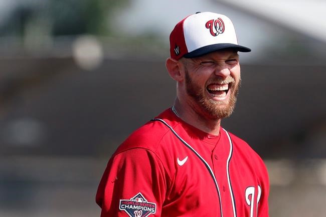 FILE - In this Feb. 14, 2020, file photo, Washington Nationals pitcher Stephen Strasburg laughs during spring training baseball practice in West Palm Beach, Fla. (AP Photo/Jeff Roberson, File)