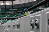 FILE - In this Dec. 15, 2019, file photo, a worker cleans above air conditioning vents at Qatar Education Stadium, an open cooled stadium with a 45,350-seat capacity, and one of the 2022 World Cup stadiums, in Doha, Qatar. Addressing airborne threats like the novel coronavirus is a particular challenge, especially when they can stick around for hours wherever they might land. The good news is many venues already use high-efficiency filtration that can capture most virus particles and keep them from spreading. The bad news is even the world‚Äôs most effective HVAC systems can‚Äôt do anything about the germs fans might touch on a railing or catch from a cough down the row. (AP Photo/Hassan Ammar, File)