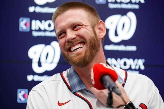FILR - In this Dec. 17, 2019, file photo, Washington Nationals pitcher Stephen Strasburg smiles during a baseball media availability at Nationals Park in Washington. The Nationals head to spring training with mostly the same squad that won the World Series. They are counting again on being led by a star-studded rotation featuring Max Scherzer and Strasburg, along with slugger Juan Soto.(AP Photo/Alex Brandon, File)