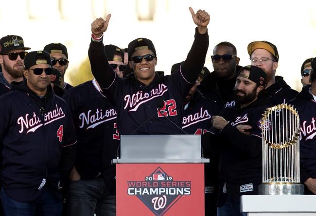 FILE - In this Nov. 2, 2019, file photo, Washington Nationals left fielder Juan Soto, center, celebrates with teammates during a rally following a parade to celebrate the team's World Series baseball championship over Houston Astros in Washington. The Nationals head to spring training with mostly the same squad that won the World Series. They are counting again on being led by a star-studded rotation featuring Max Scherzer and Stephen Strasburg, along with slugger Soto. (AP Photo/Jose Luis Magana, File)