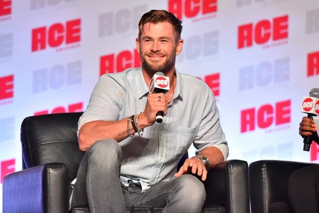 FILE - In a Sunday, Oct. 13, 2019 file photo, Chris Hemsworth participates during a Q&A panel on day three at the Ace Comic-Con in Rosemont, Ill. Elton John and Chris Hemsworth are among the celebrities donating big bucks to help aid the efforts for the engulfing wildfires in Australia. (Photo by Rob Grabowski/Invision/AP, File)