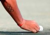 FILE - In a Thursday, Feb. 28, 2019 file photo, Rickie Fowler's Olympic tattoo is shown as he places his ball on the 10th hole before putting during the first round of the Honda Classic golf tournament in Palm Beach Gardens, Fla. For Americans, making the Olympic team is the most difficult of any team event. (AP Photo/Wilfredo Lee)