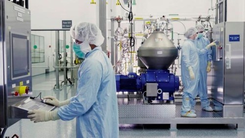 In this undated image from video provided by Regeneron Pharmaceuticals on Friday, Oct. 2, 2020, scientists work with a bioreactor at a company facility in New York state, for efforts on an experimental coronavirus antibody drug. Antibodies are proteins the body makes when an infection occurs; they attach to a virus and help the immune system eliminate it. (Regeneron via AP)