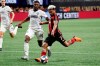 FILE - In this Oct. 24, 2019, file photo, Atlanta United forward Josef Martinez (7) scores a goal as Philadelphia Union defender Mark McKenzie (4) defends during the second half of an MLS soccer Eastern Conference semifinal in Atlanta. One of the most dynamic strikers in Major League Soccer history, and the face of Atlanta United's stunning rise to the top of the league, Martinez missed nearly all of last season recovering from a serious knee injury. (AP Photo/John Bazemore, File)