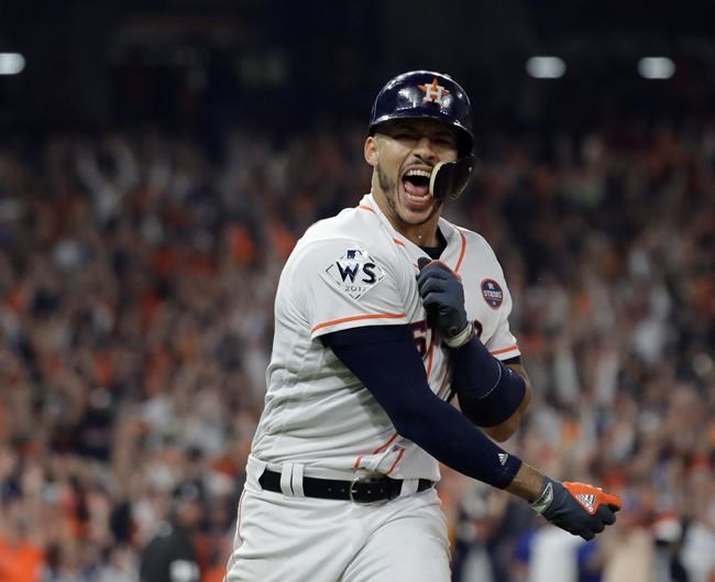 FILE - In this Oct. 29, 2017, file photo, Houston Astros' Carlos Correa celebrates his two-run home run during the seventh inning of Game 5 of baseball's World Series against the Los Angeles Dodgers in Houston. While the Astros have been punished by Major League Baseball for a sign-stealing scheme in their run to the 2017 championship, and Correa says Houston won that World Series “fair and square.” (AP Photo/David J. Phillip, File)