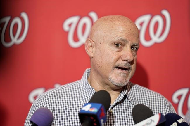 FILE - In this Jan. 11, 2020, file photo, Washington Nationals general manager Mike Rizzo talks with members of the media during the team's